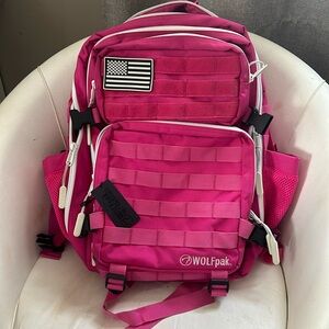 Used hot pink Wolf backpack. 3 sections with padded pockets